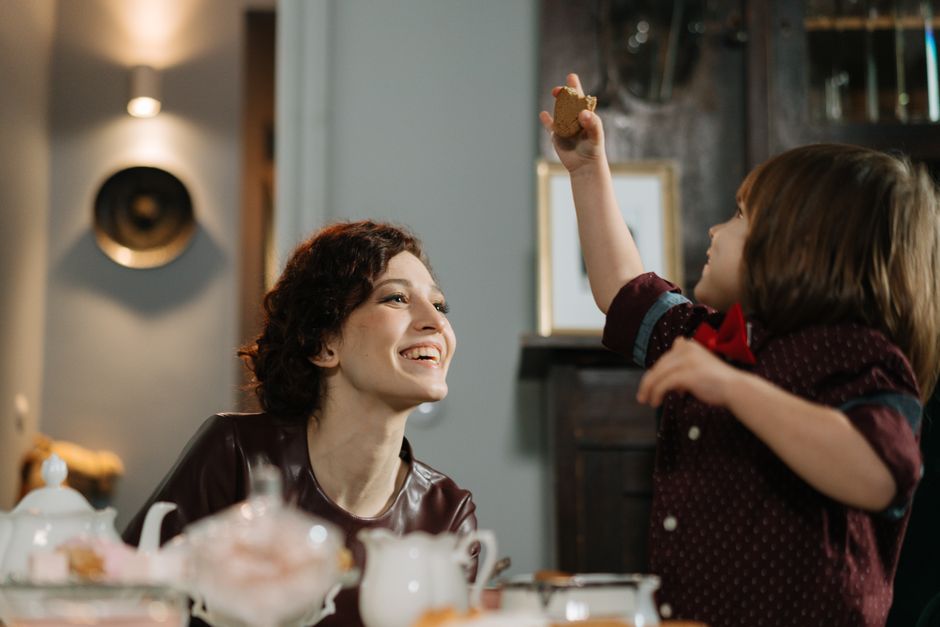 A smiling babysitter and child